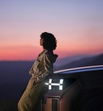 a woman sitting on the hood of a car